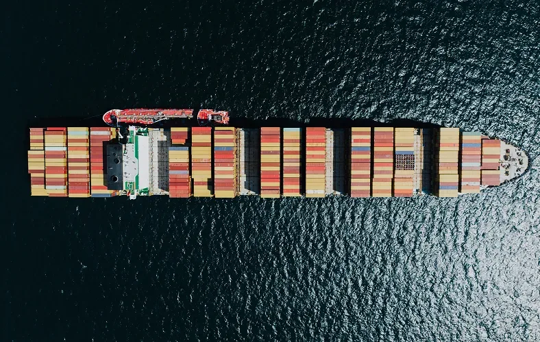 Real photo: aerial view of a fully loaded container ship crossing the ocean