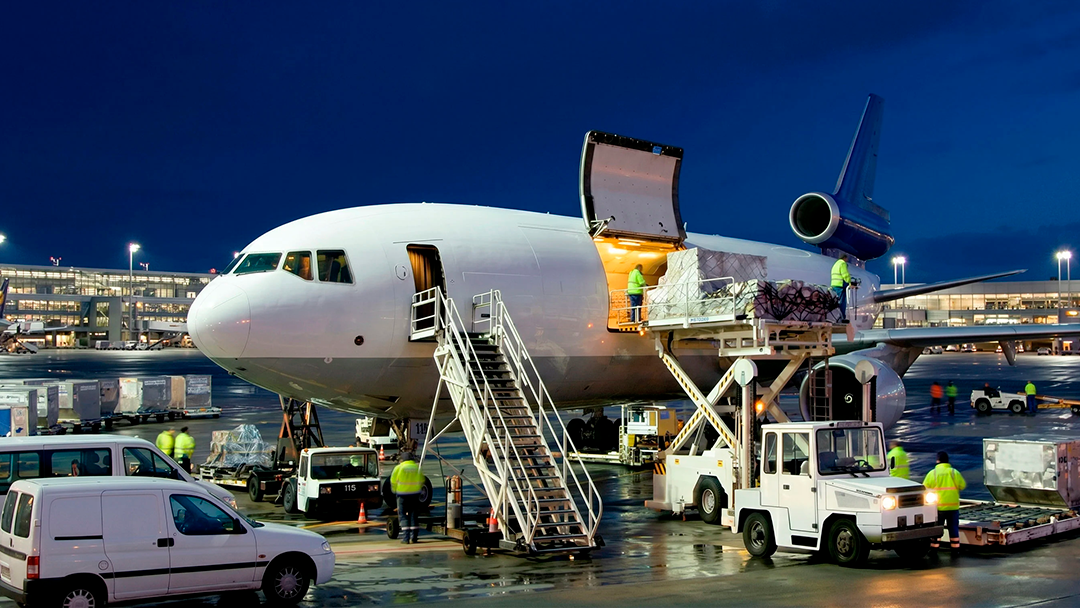 Freighter aircraft being loaded on the ramp at dusk